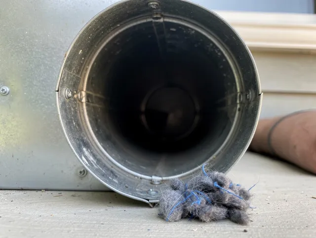 Lynnfield Dryer Vent Cleaning technician using specialized equipment to clear severe dryer vent blockage in Lynnfield